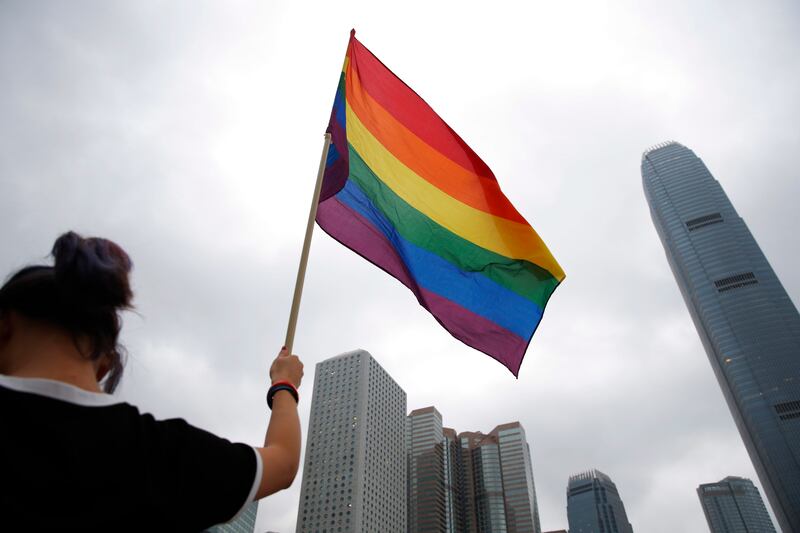 A participant holds a rainbow flag at the annual Pride Parade in Hong Kong in 2018 (Kin Cheung/AP)