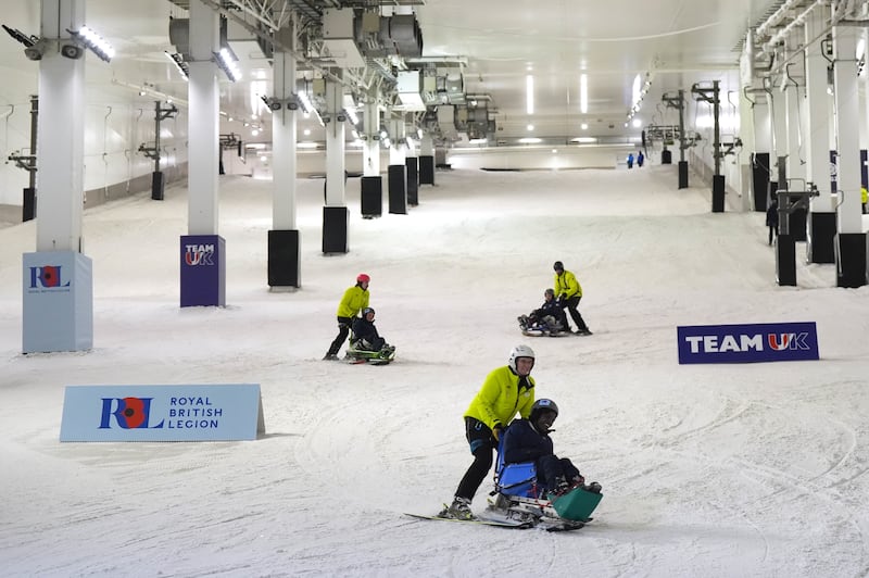 Invictus Team UK members take to the slopes during the launch event. Jacob King/PA