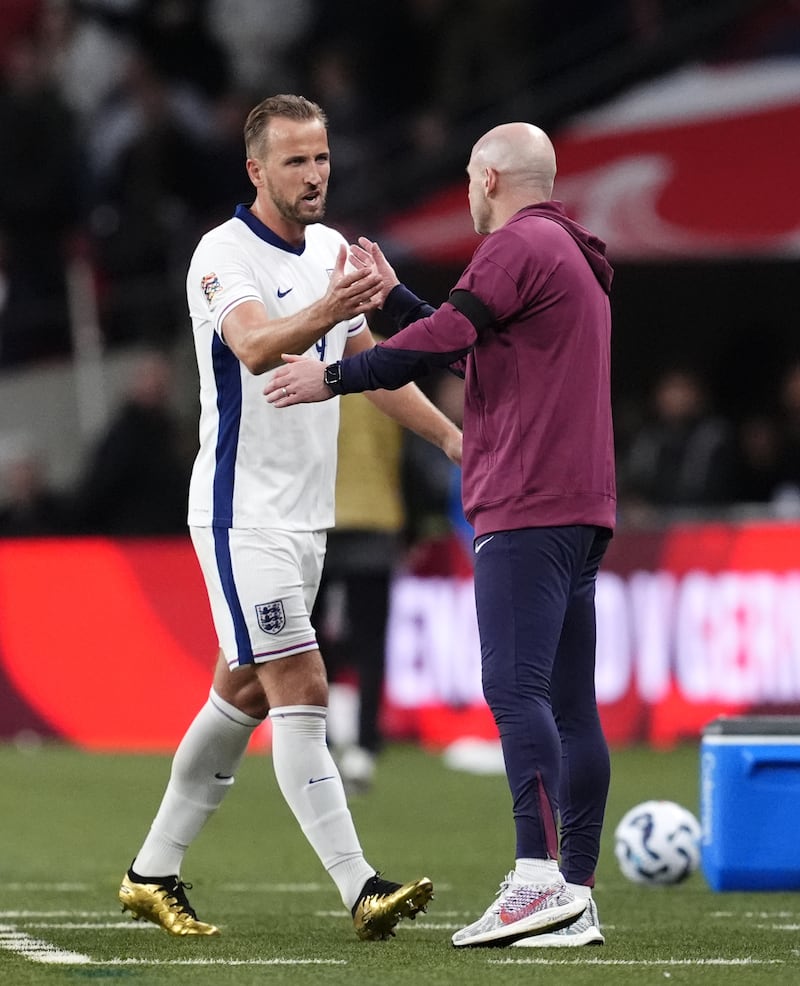 Lee Carsley, right, congratulates Harry Kane as he is substituted