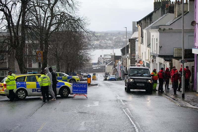 Emergency workers gather near the Torpoint Ferry crossing in Plymouth where a suspected Second World War explosive device will be taken to be disposed of at sea