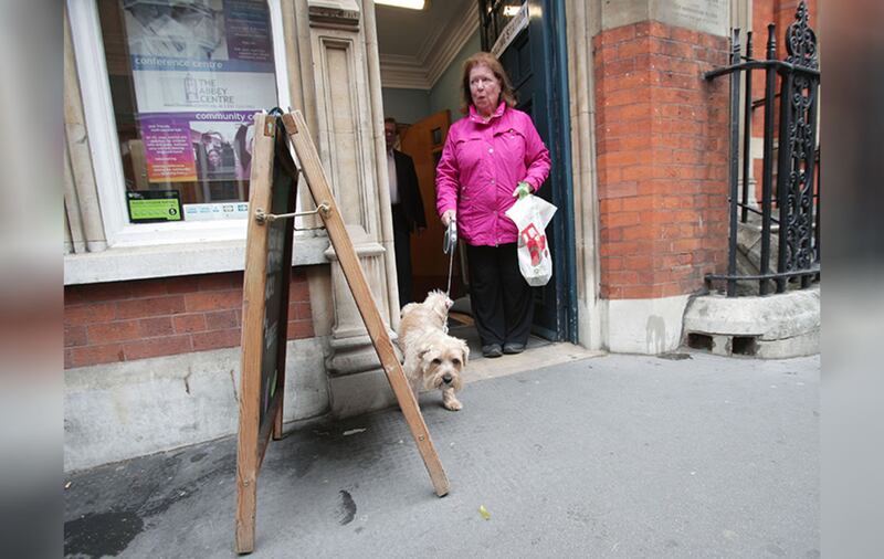 A voter's dog cocks its leg against the doorway of a polling station in The Abbey Centre on Great Smith Street, London, as people cast their votes in the General Election. Picture by&nbsp;Yui Mok/PA Wire