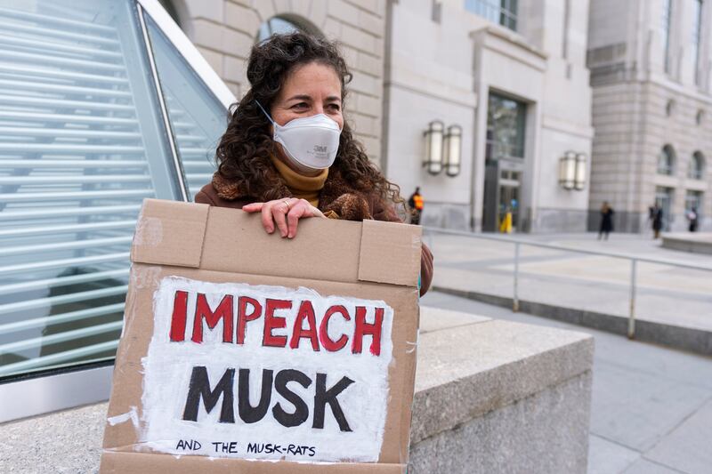 A United States Agency for International Development, or USAID contract worker with a placard protesting the cessation of USAID (Manuel Balce Ceneta/AP)