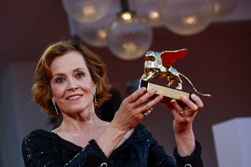 Sigourney Weaver poses with the lifetime achievement award at the opening ceremony of the 81st edition of the Venice Film Festival (Joel C Ryan/Invision/AP)