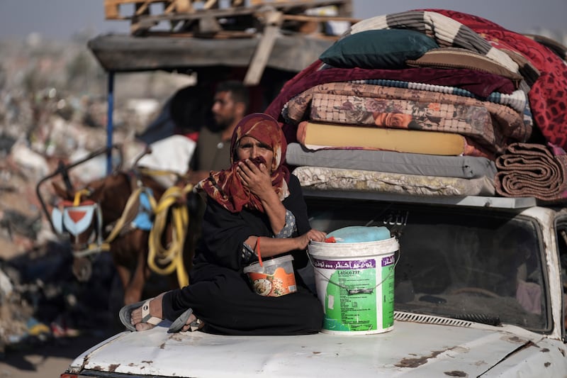 A Palestinian woman flees the Khan Younis area of the Gaza Strip (Abdel Kareem Hana/AP)