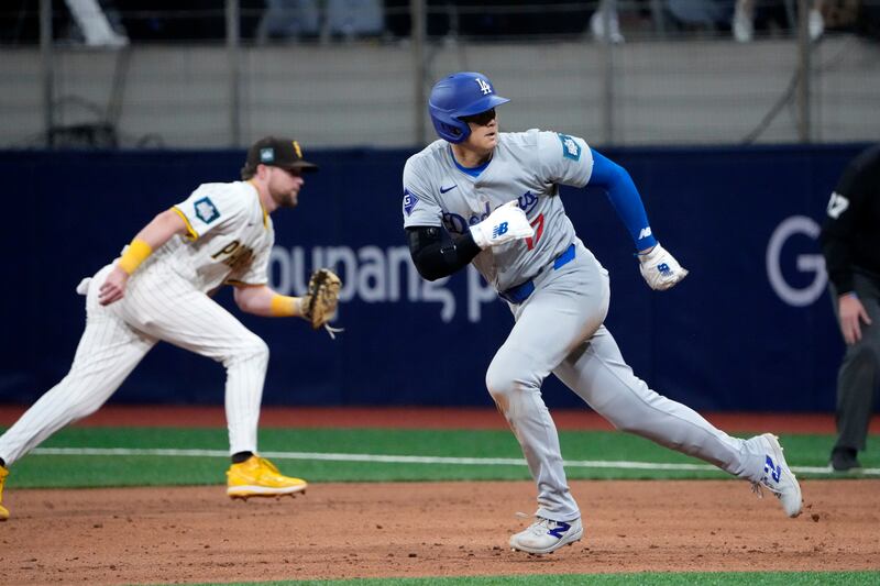 Los Angeles Dodgers designated hitter Shohei Ohtani, right, during the eighth inning of an opening day baseball game against the San Diego Padres in Seoul (Ahn Young-joon/AP)