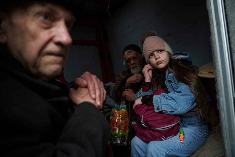 Hanna, 12, and her family sit inside a van during an evacuation from Pokrovsk, Ukraine (Evgeniy Maloletka/AP)