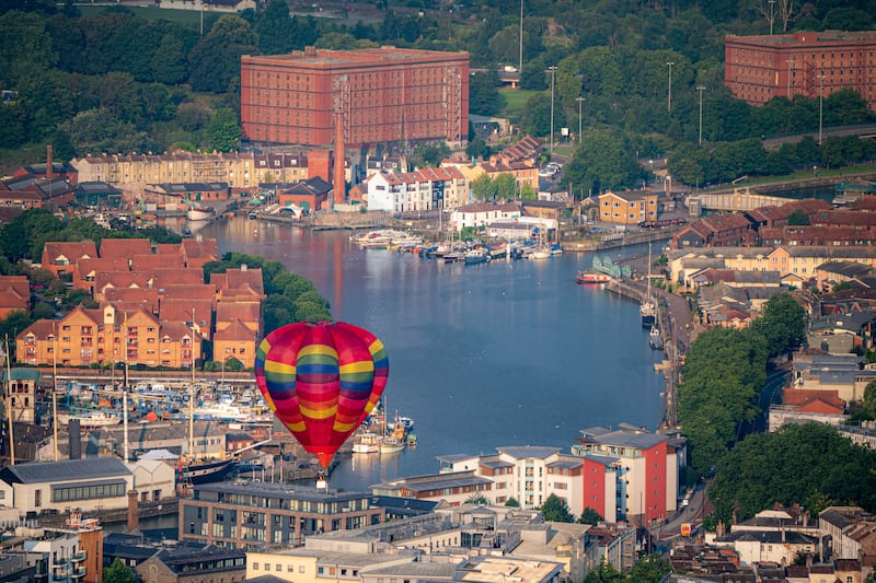 A hot air balloon takes to the sky over Bristol Harbour