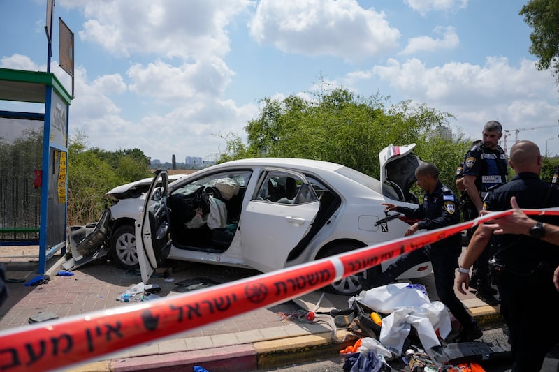 Israeli police officers work at the scene of a ramming attack near Ramla, Israel (Ohad Zwigenberg/AP)