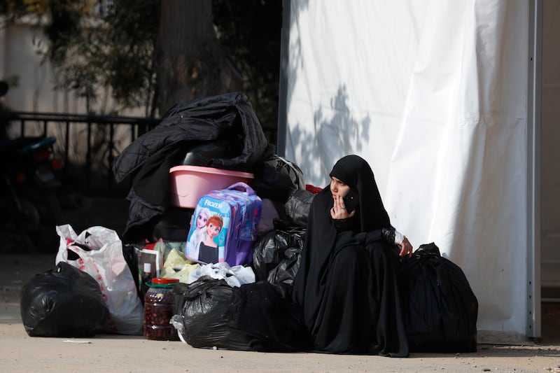 A girl waits at the border between Lebanon and Syria as Lebanese families return to Lebanon (Omar Sanadiki/AP)