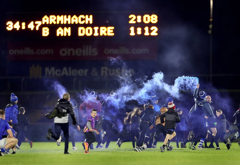 Ballinderry supporters race onto the pitch at the final whistle to celebrate after beating Arva during the Ulster Club Intermediate Football Championship final