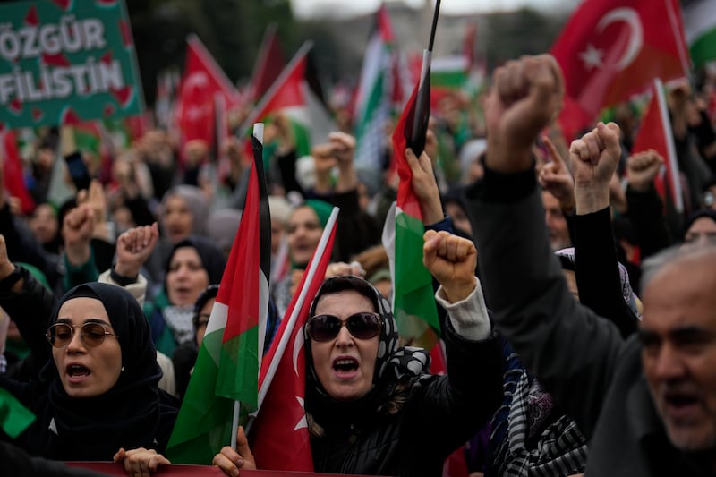 People protest in support of Palestinians in Gaza during a protest rally in Istanbul (Khalil Hamra/AP)