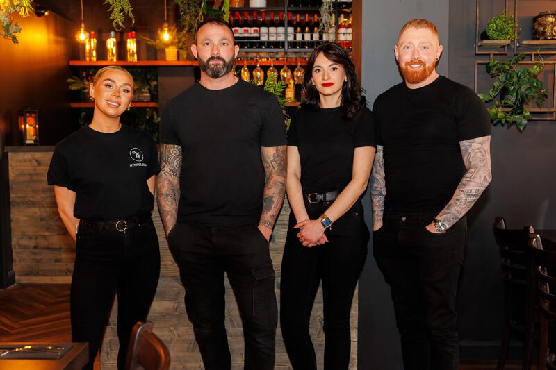 Kristian Nicolo and Stephen Toney with members of their team inside Nico's new Ormeau Road restaurant.