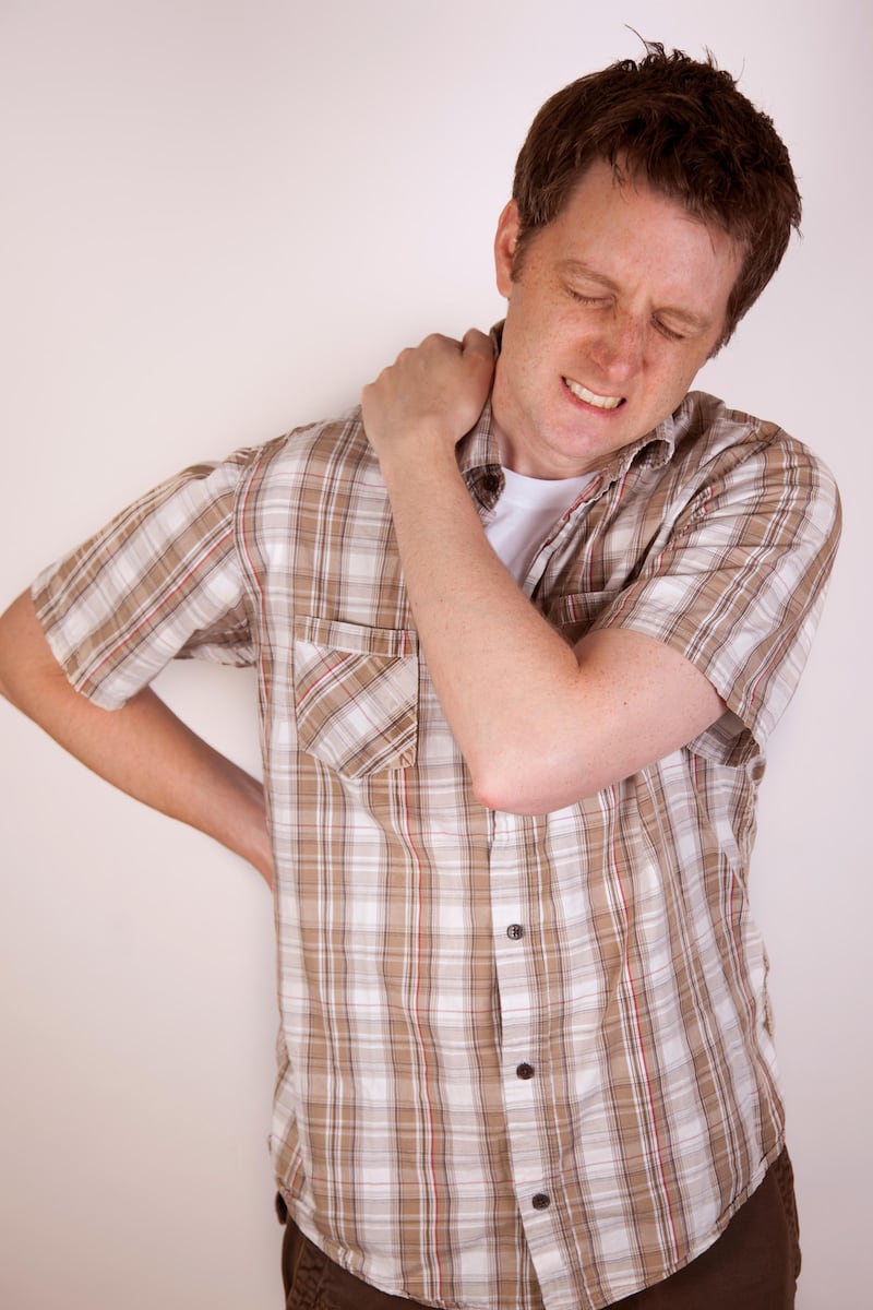 Man holding his shoulder in pain