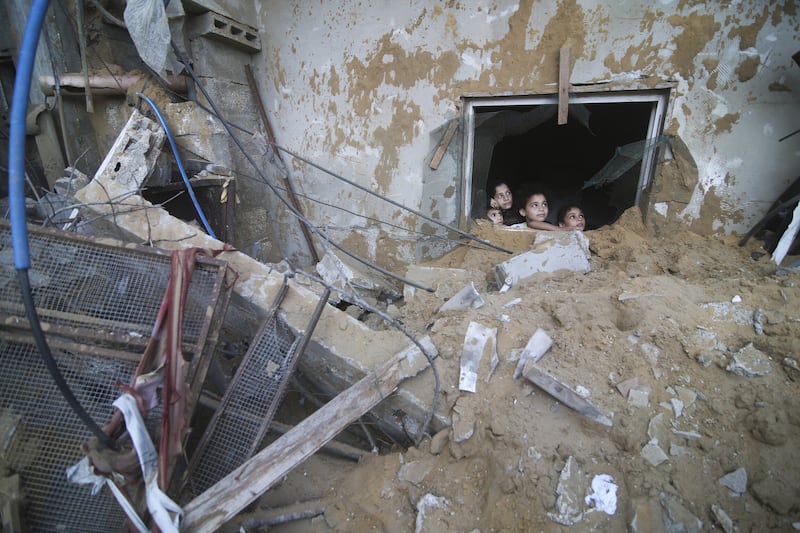 Israel has pounded neighbourhoods in Gaza with airstrikes (Hatem Ali/AP)