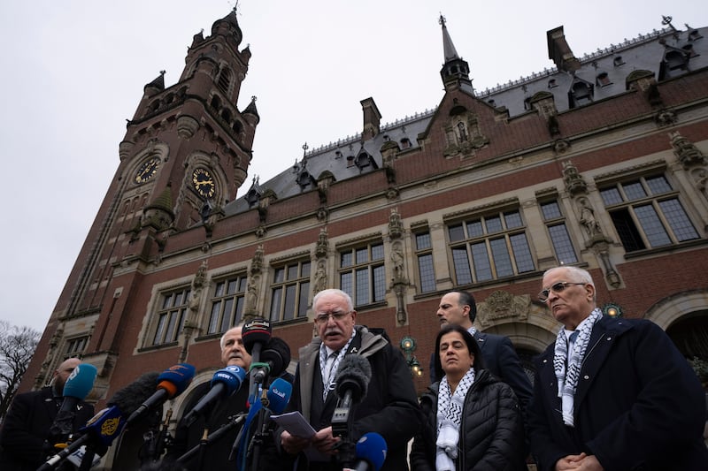 Riad Malki, the Palestinian National Authority’s foreign minister, centre, gives a statement outside the Peace Palace in The Hague, Netherlands, on Monday (Peter Dejong/AP)