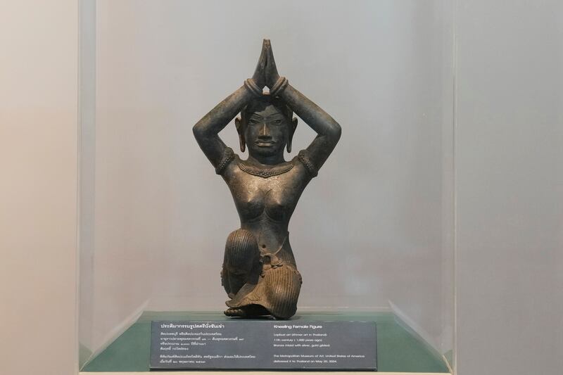 The ancient bronze kneeling woman sculpture is displayed during a repatriation ceremony at the National Museum in Bangkok, Thailand (Sakchai Lalit/AP)