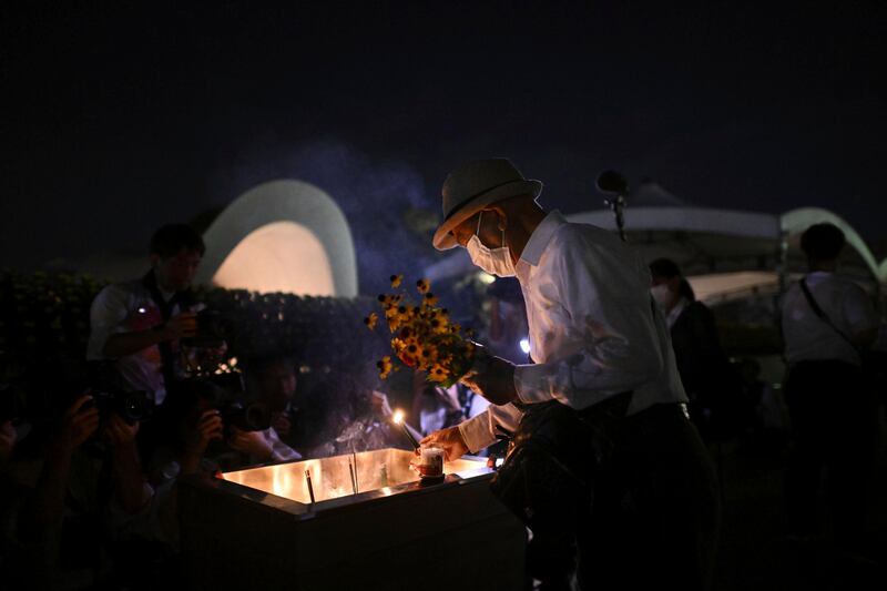 A man places incense in front of the cenotaph (Yu Nakajima/AP)