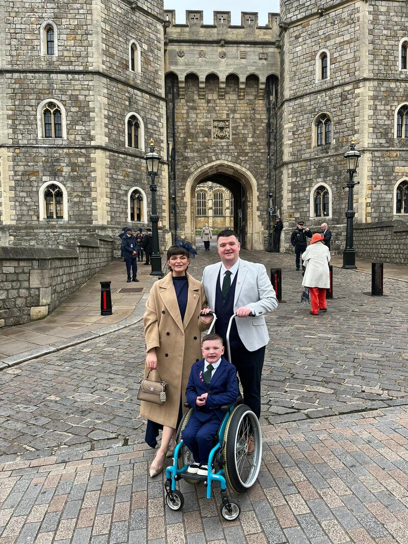 Seph and Máirtín MacGabhann and son Dáithí picking up the MBE award