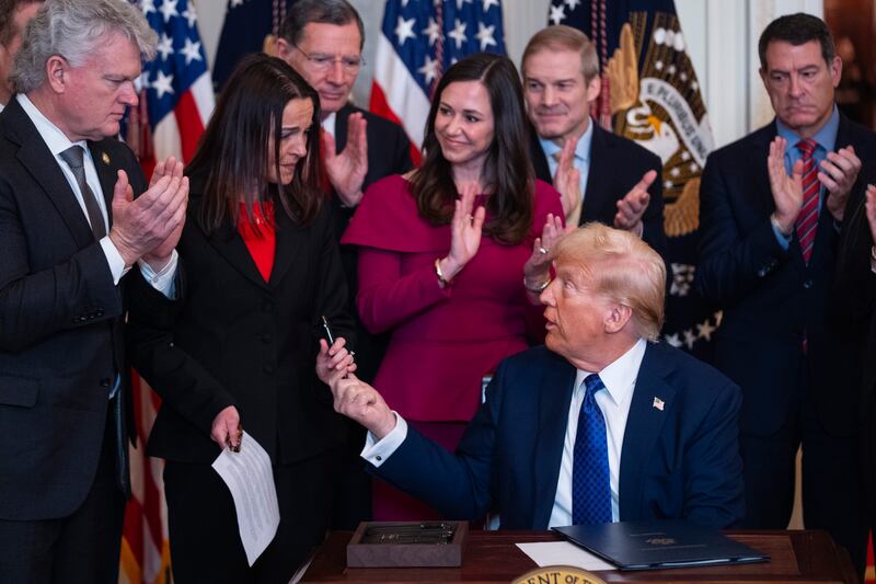 Donald Trump with Allyson Phillips, the mother of Laken Riley, after signing the Laken Riley Act in the White House (Evan Vucci/AP)