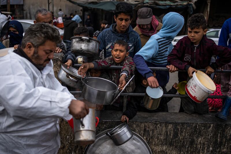 Palestinians line up for food aid in Rafah (Fatima Shbair/AP)