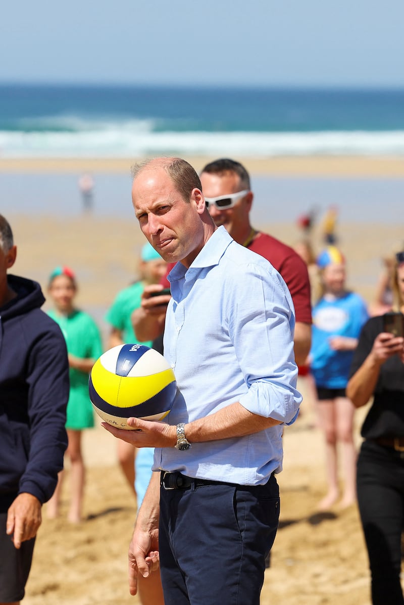 William takes part in a game of volleyball during a visit to Fistral beach in Newquay