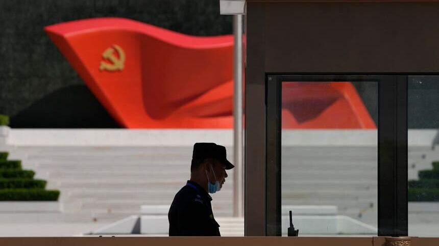 A security guard stands near a sculpture of the Chinese Communist Party flag at the Museum of the Communist Party of China in Beijing (Ng Han Guan/AP)