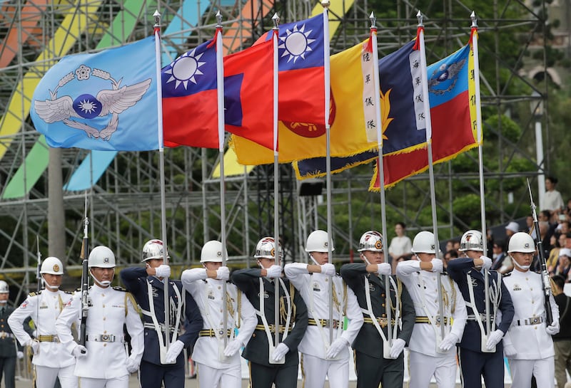 Members of an honour guard held flags during the inauguration ceremony in Taipei (Chiang Ying-ying/AP)