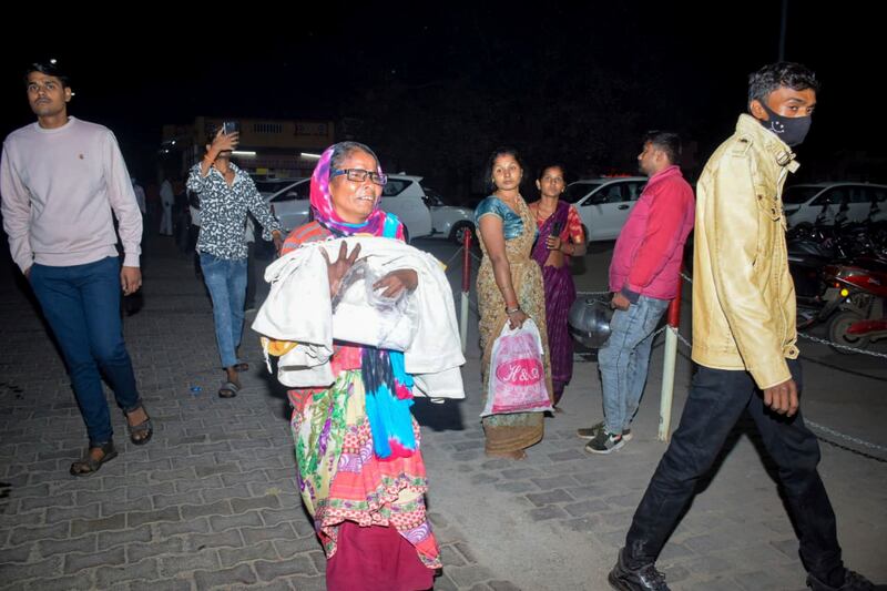 Families rushed to the scene after the fire (AP)