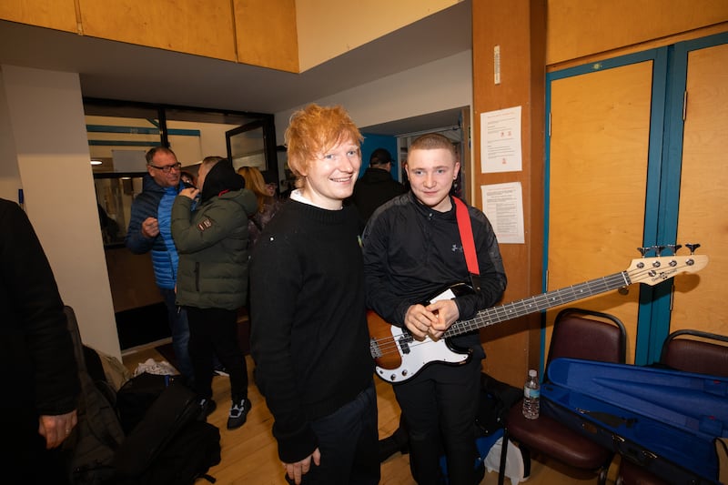 Ed Sheeran poses for a photo with a youngster involved with the Tinderbox Collective.