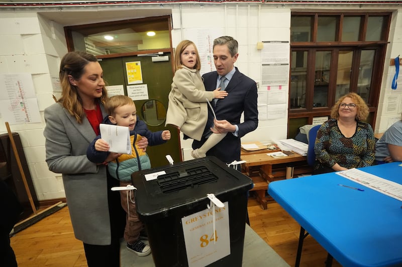 Taoiseach and Fine Gael leader Simon Harris, with his wife Caoimhe and children Cillian and Saoirse, casts his vote