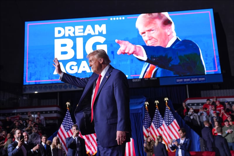 Donald Trump waves at a campaign rally at Van Andel Arena in Grand Rapids, Michigan on Monday night (Evan Vucci/AP)