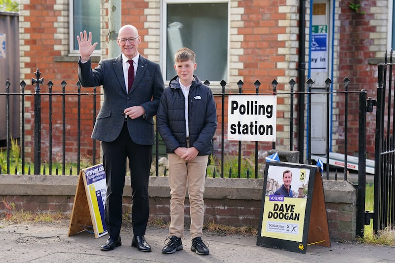 John Swinney and his son Matthew arrive at Burreltown Village Hall as the First Minister cast his ballot