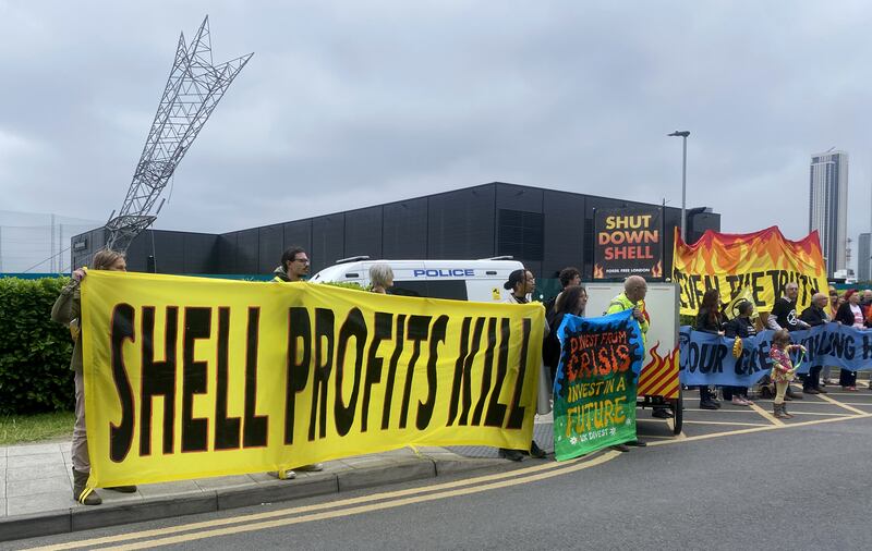 Protesters held banners reading ‘Shell profits kill’ outside the oil giant’s AGM