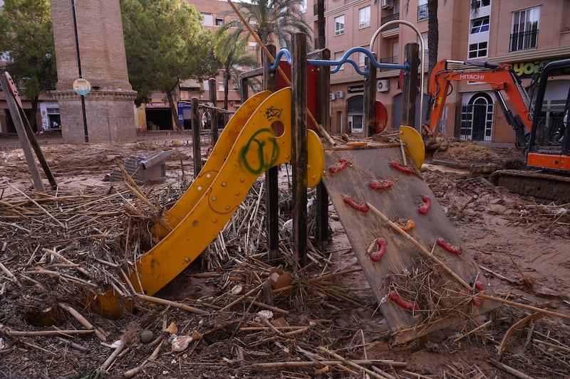 A children’s slide in a playground is covered with debris after floods in Catarroja (Alberto Saiz/AP)