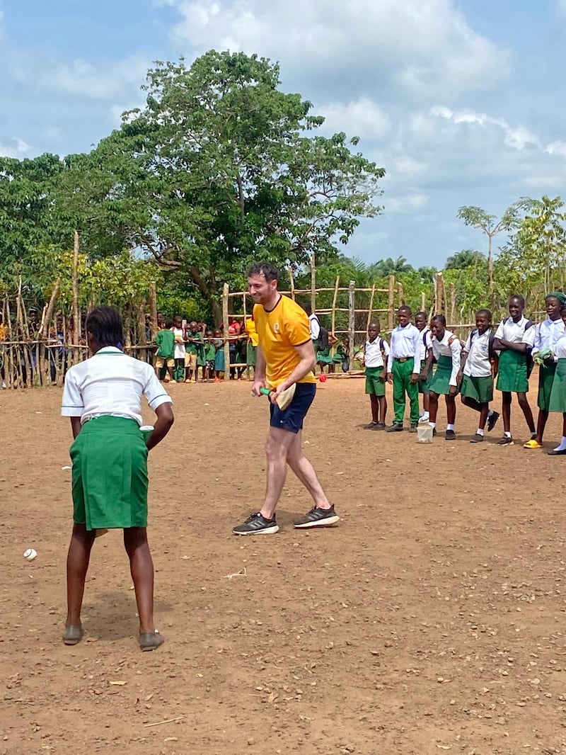 Galway hurler Padraic Mannion teaches the basics of the game to pupils at a school in Freetown