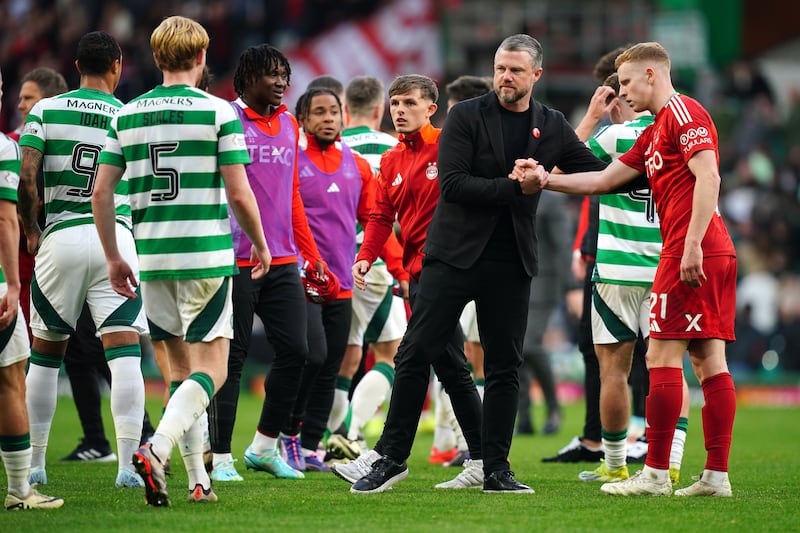 Aberdeen manager Jimmy Thelin shakes hands with Gavin Molloy after the 2-2 draw at Celtic Park