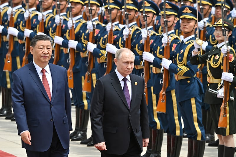 The leaders review the honour guard of Chinese troops (Sergei Bobylev, Sputnik, Kremlin Pool Photo via AP)