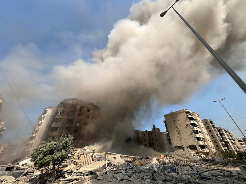 Smoke rises as a building collapses in Beirut’s southern suburbs (Hussein Malla/AP)