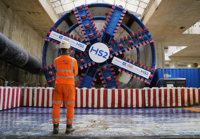 An HS2 worker stands in front of tunnel boring machine Karen at the Old Oak Common station box site