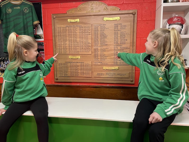 Sisters Madison and Mila Hawkins look at the new Holy Trinity roll of honour