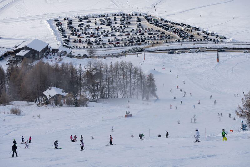 People sking snowboarding down the slope. Town of Livigno in winter. Livigno landskapes in Lombardy, Italy, located in the Italian Alps, near the Swis