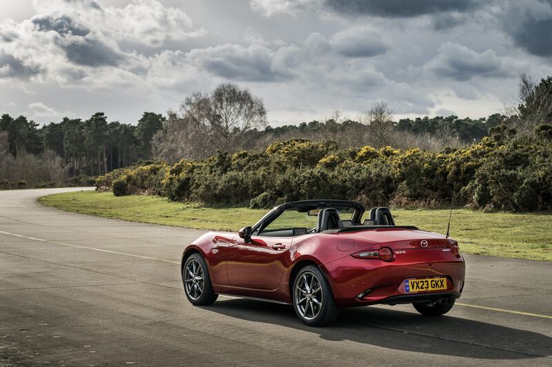 The shrink-wrapped MX-5's hood can be operated one-handed in about the same time it takes to put up an umbrella