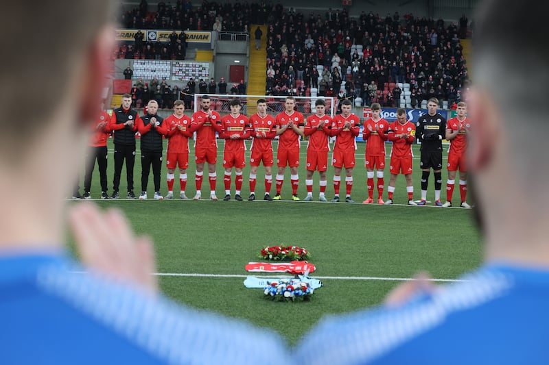 Cliftonville football club pay tribute to their former team-mate, the late Michael Newberry before their Irish Cup game against Banbridge Rangers