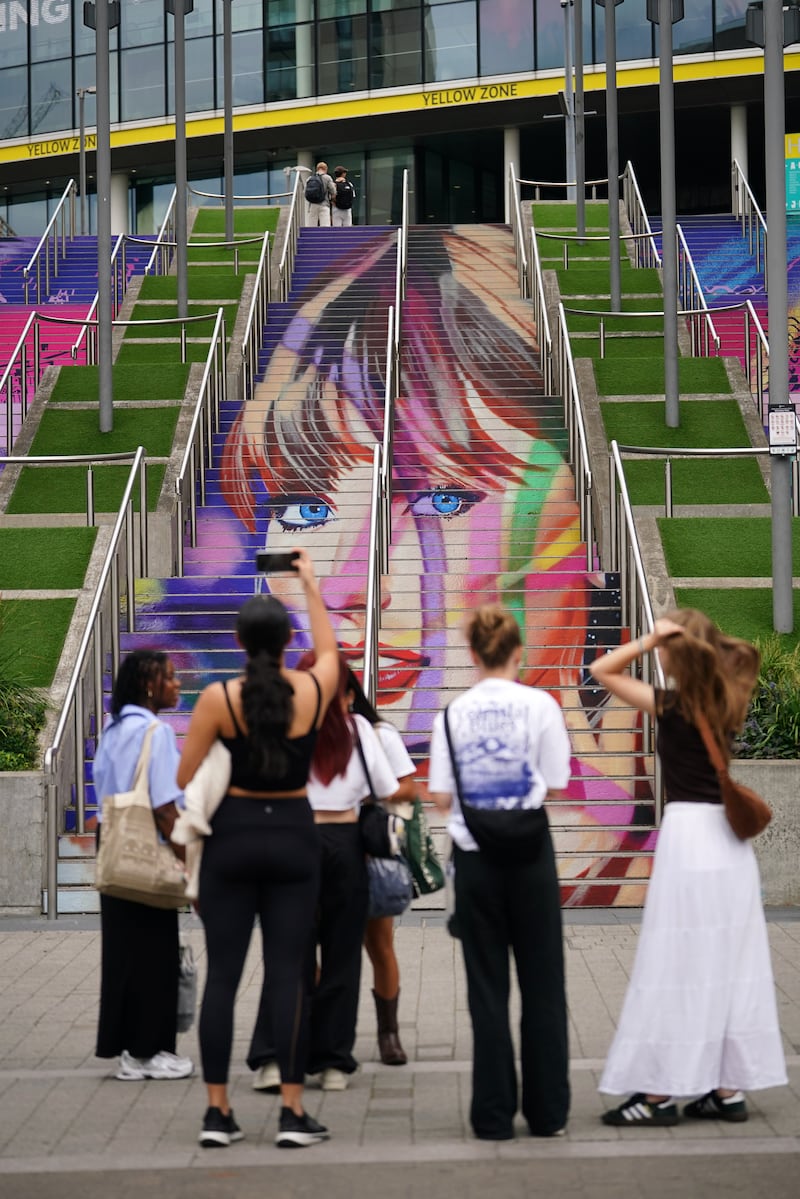 Swifties take photographs of the Swiftie Steps and murals at Wembley Park, ahead of Taylor Swift’s Era’s Tour concert on Thursday