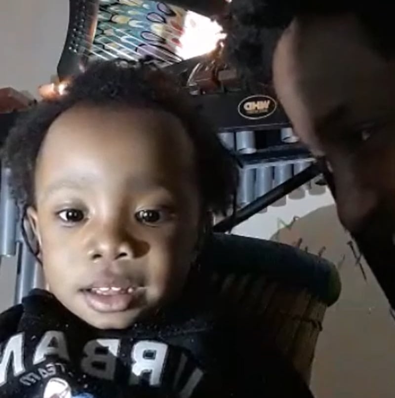 Abiyah, seen with his father in a family video