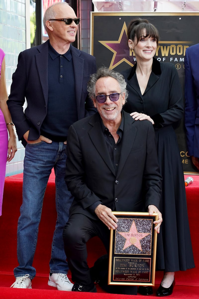 Michael Keaton, Tim Burton and Winona Ryder at a ceremony honouring Burton with a star on the Hollywood Walk of Fame (Jordan Strauss/Invision/AP)