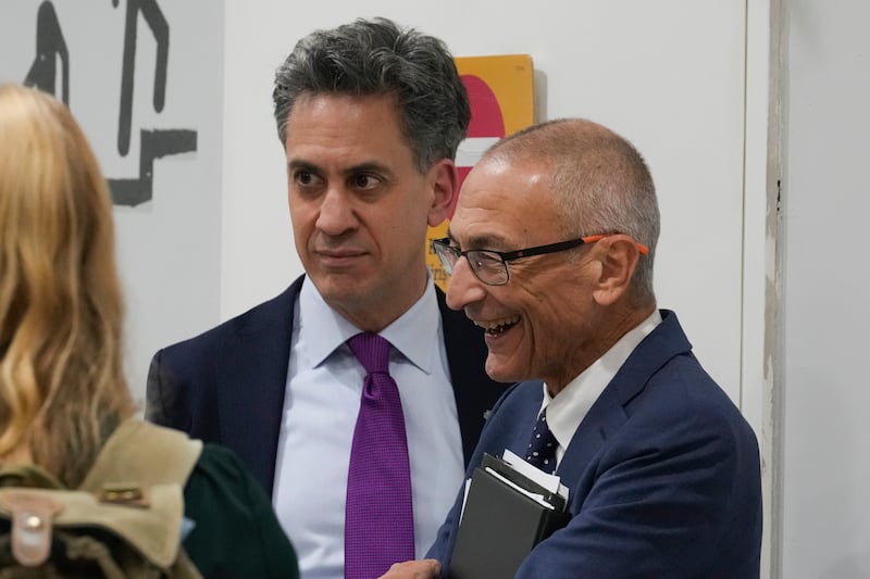 Ed Miliband, United Kingdom energy minister, centre, speaks with John Podesta, US climate envoy at Cop29 (Rafiq Maqbool/AP)