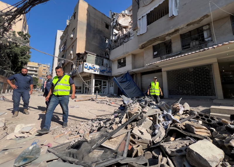 An Israeli air strike hit a suburb of Beirut on Tuesday, with Tel Aviv saying it had targeted a Hezbollah commander responsible for a rocket attack that killed 12 children (AP)