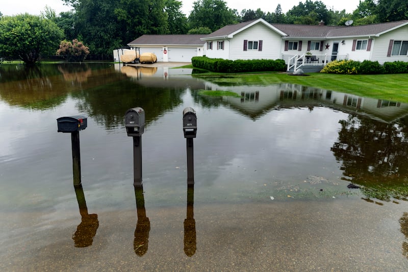 Roads and homes were flooded (Jake May/The Flint Journal via AP)