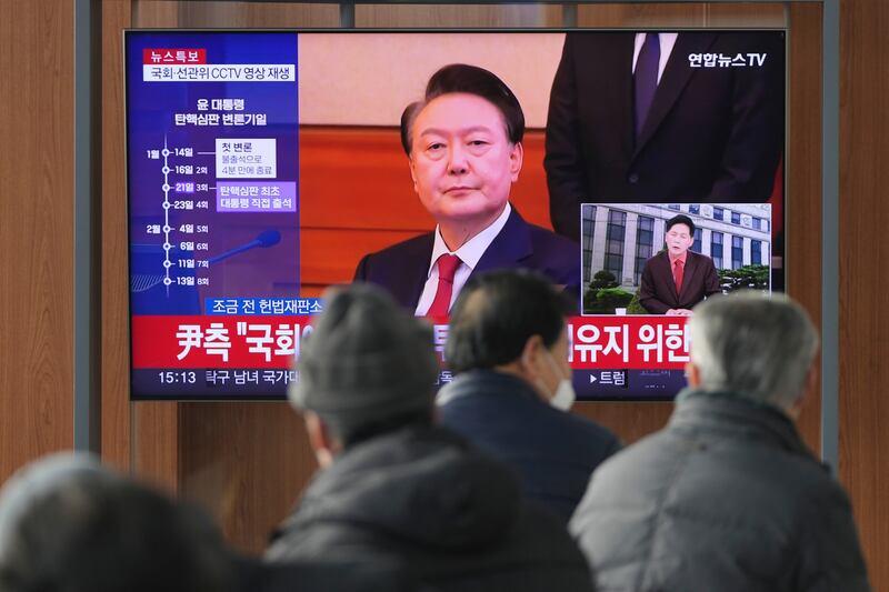 A TV screen shows footage of impeached South Korean President Yoon Suk Yeol at the Seoul Railway Station (Lee Jin-man/AP)